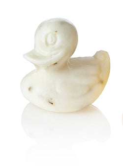A duck-shaped white soap with subtle specks.