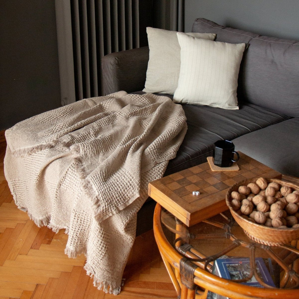 Anza Beige Duello Waffle Throw laid flat on sofa
