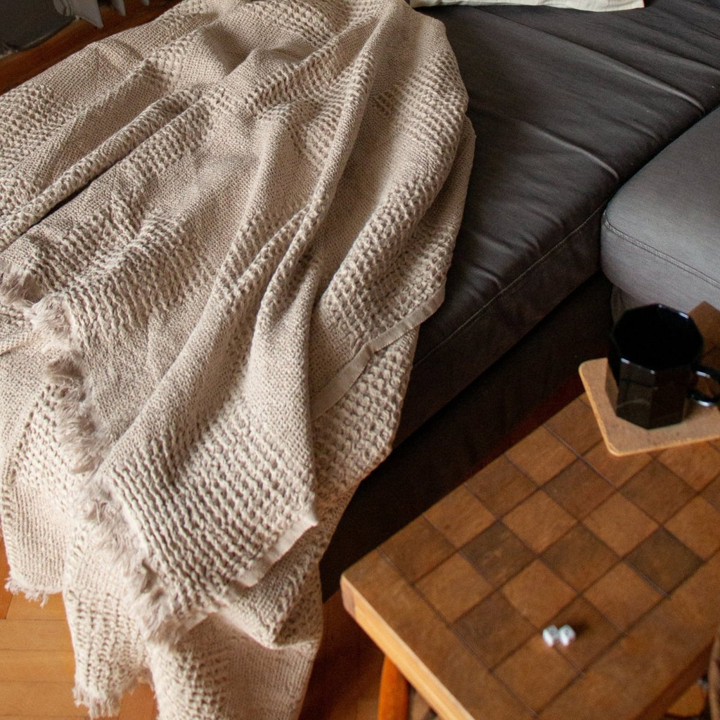Anza Beige Duello Waffle Throw laid flat on sofa