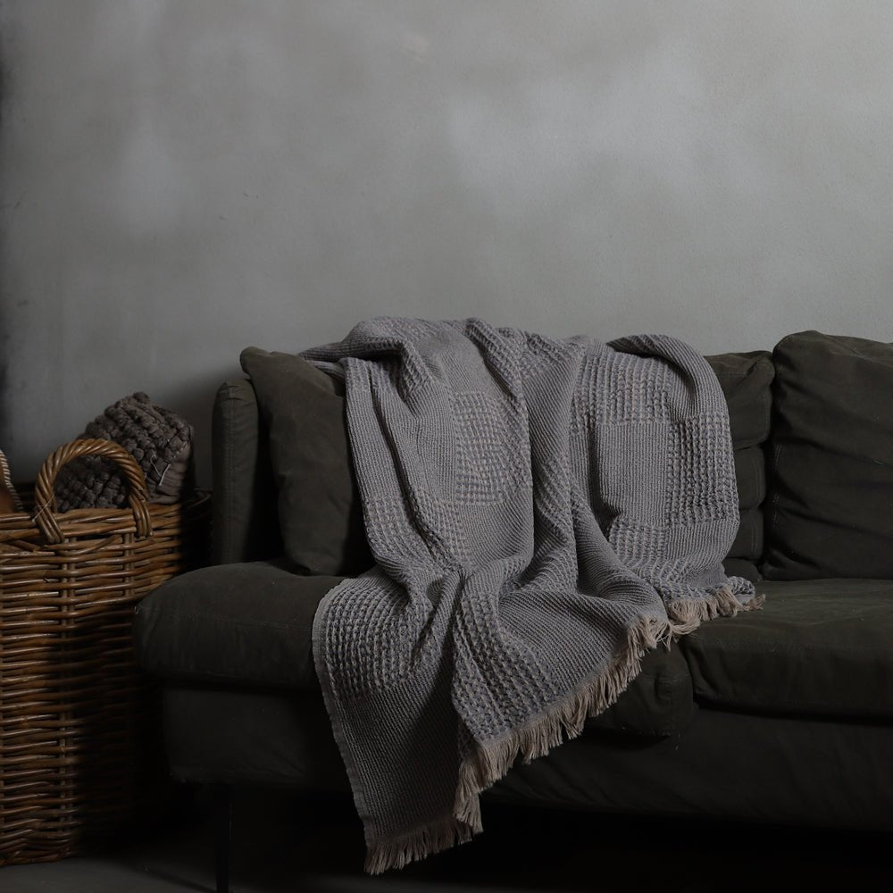 Anza Charcoal Grey Duello Waffle Throw on sofa