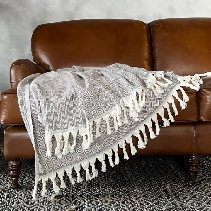 Anza Brown Herringbone Throw on sofa