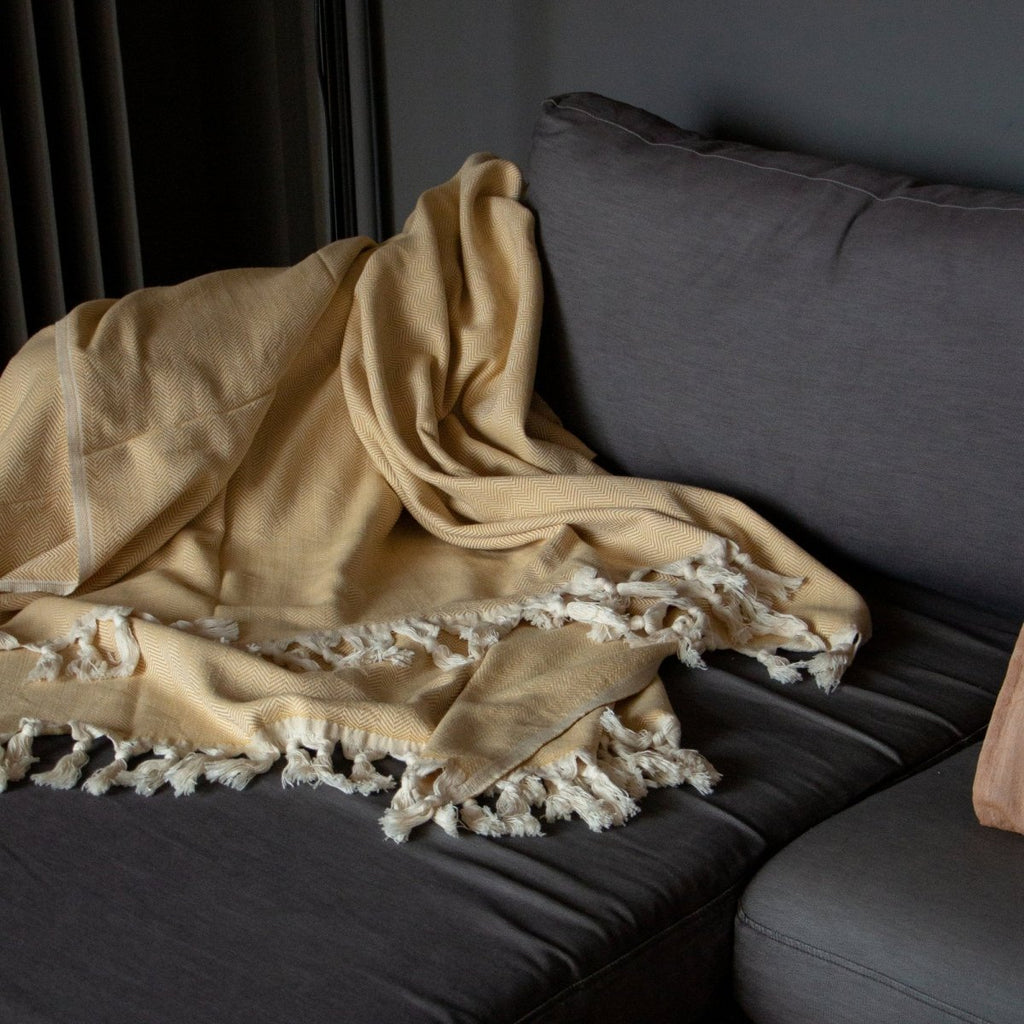 Anza Mustard Herringbone Throw on sofa