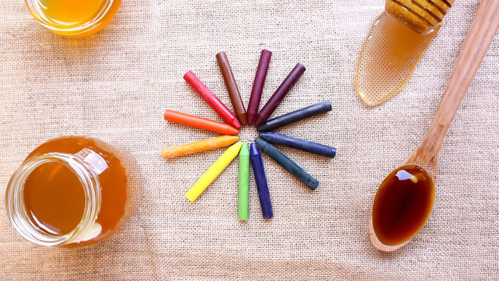 Colorz Natural Beeswax Crayons 12 Count arranged in a circle, next to honey jars