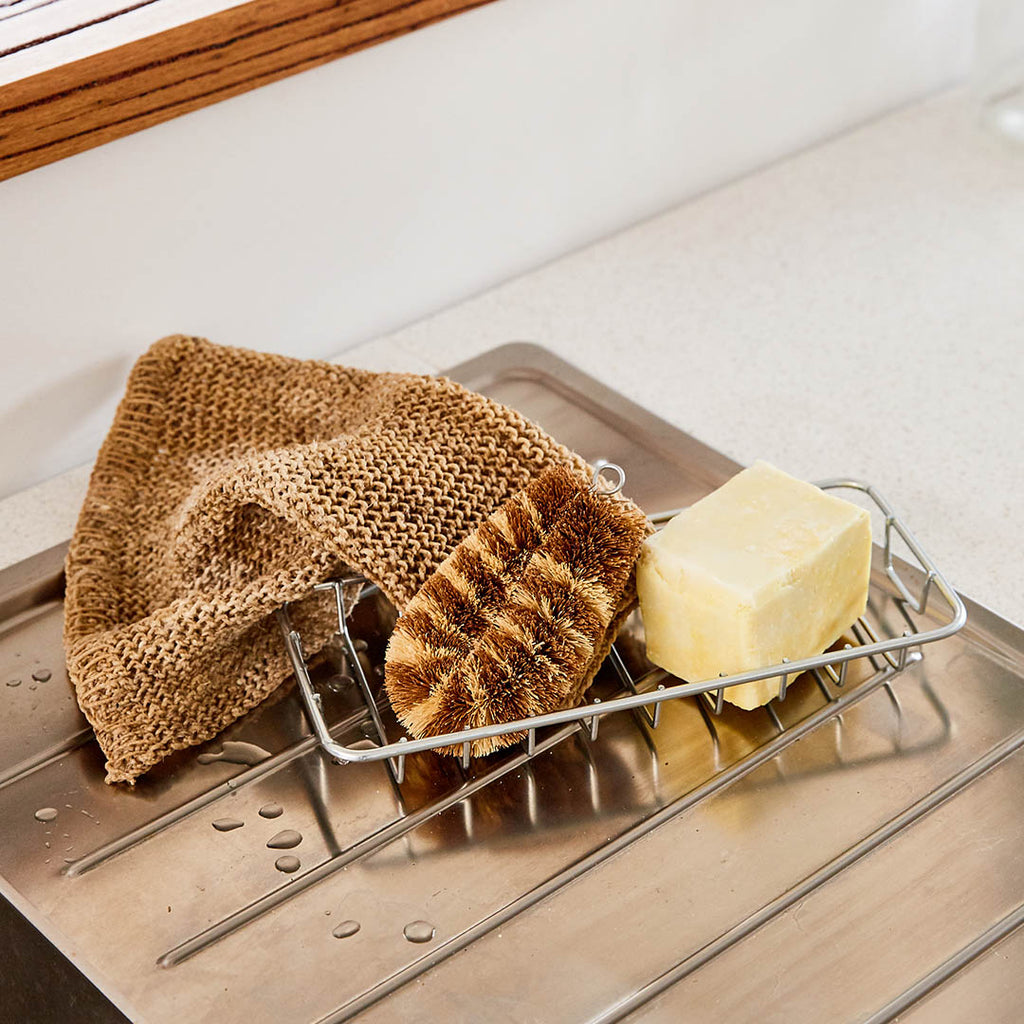 Eco Max Pot Scourer with dish soap and dish cloths on a kitchen sink