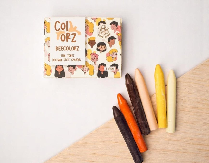 Box of Colorz Skin Tones Natural Beeswax Crayons 6 Count on a light wooden surface.