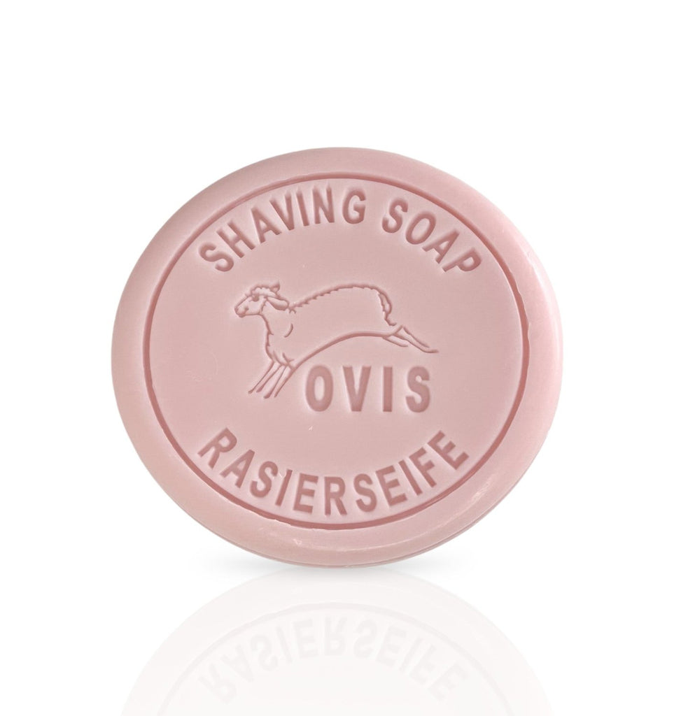 A round, pink shaving soap embossed with a sheep and text.