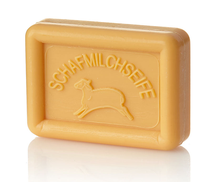 Rectangular light orange soap bar with a sheep and "SCHAFMILCHSEIFE" embossed on it.