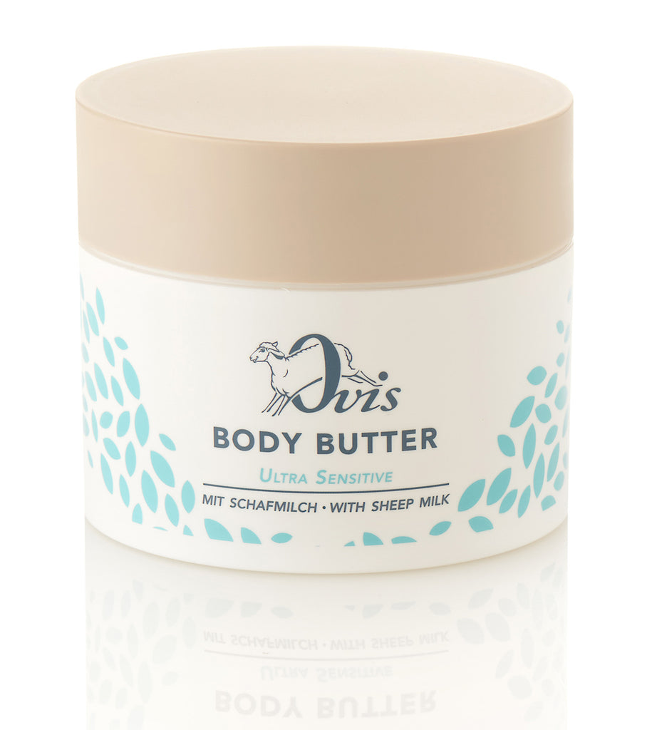 A white container of body butter with a beige lid and blue leaf pattern.
