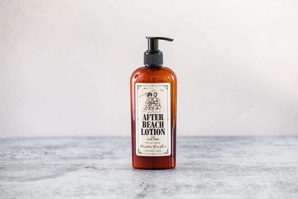 A brown bottle of "After Beach Lotion" with a black pump and a vintage-style label with an illustration of a man and a woman.