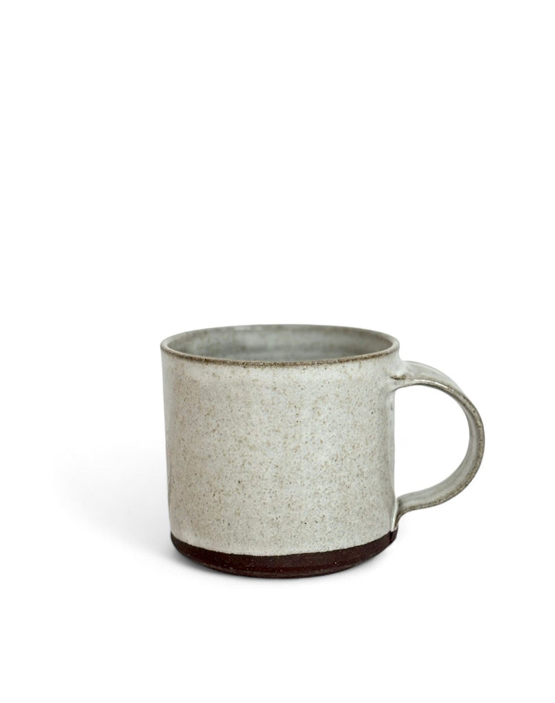 A gray speckled ceramic mug with dark brown coating on the bottom.
