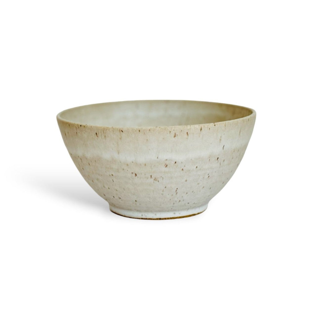 A large beige speckled ceramic bowl.