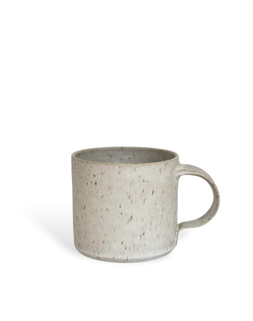 A beige speckled ceramic mug.