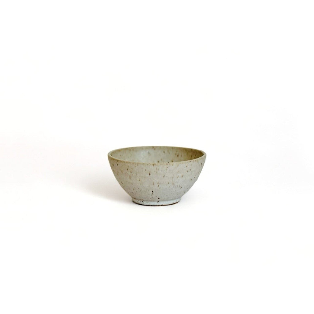 A small beige speckled ceramic bowl.