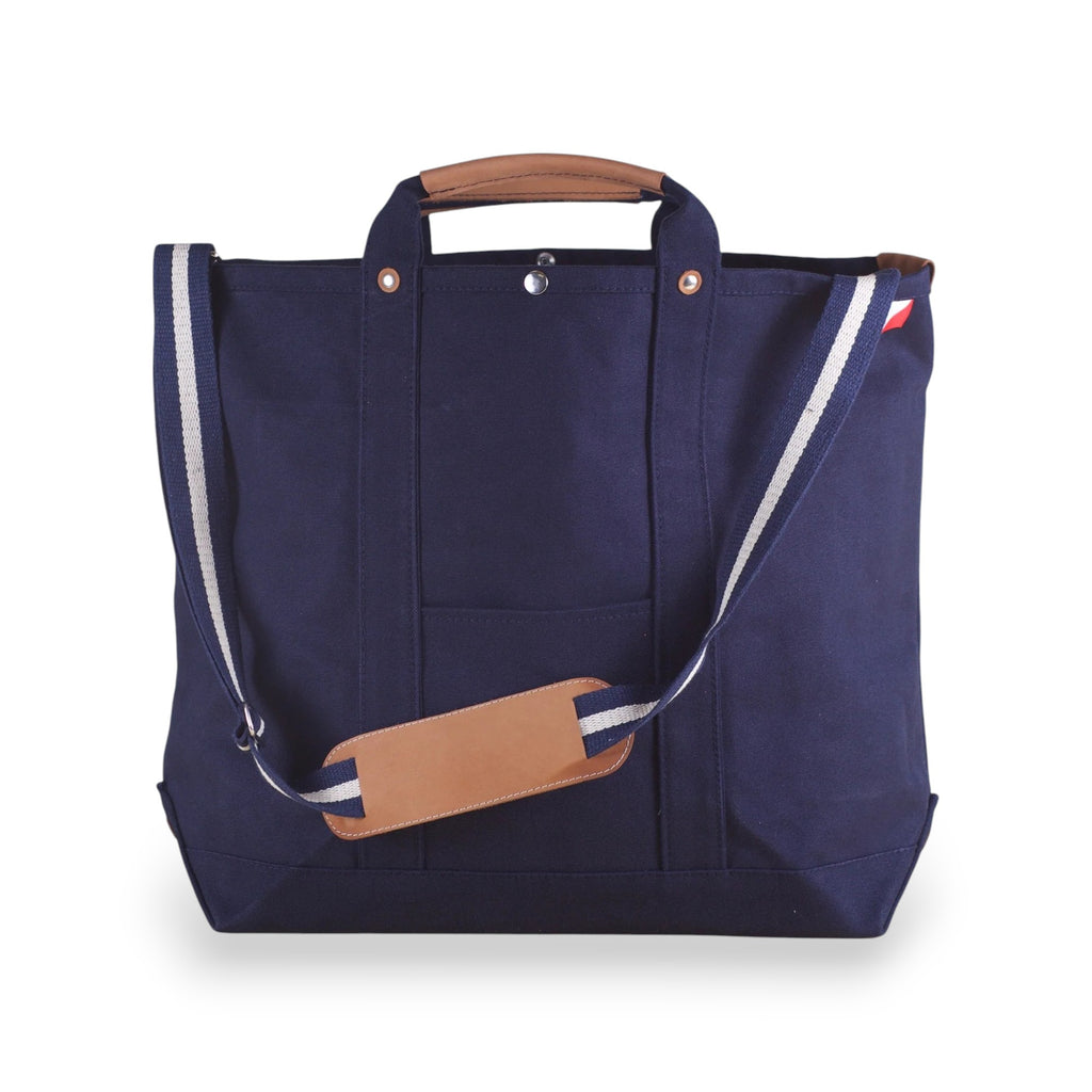 ShoreBags Navy Cargo Canvas Travel Tote bag with brown leather handles and an adjustable shoulder strap.