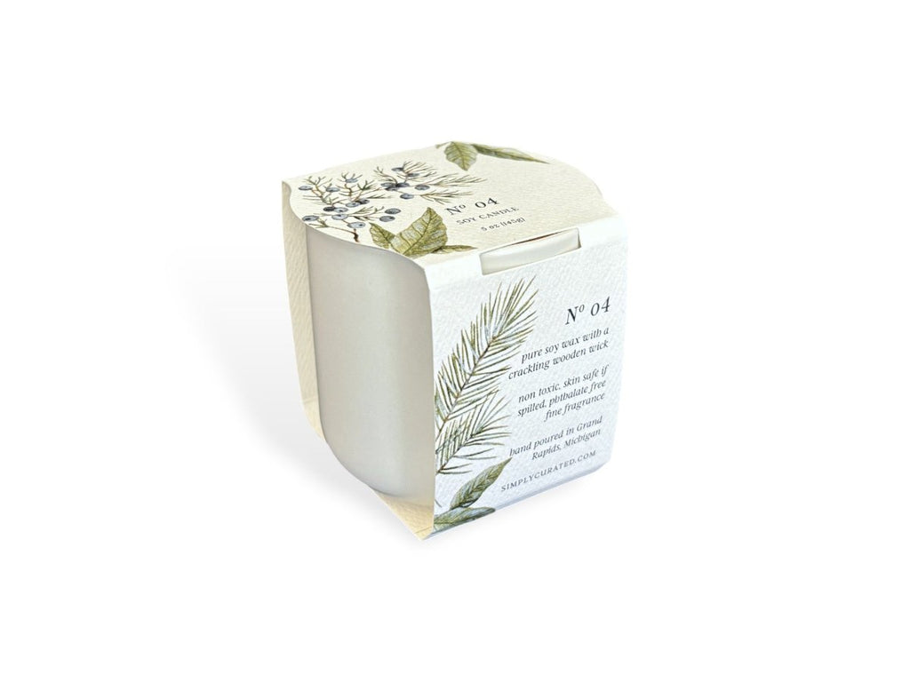 A soy candle in white packaging with botanical illustrations and labeled "Nº 04"