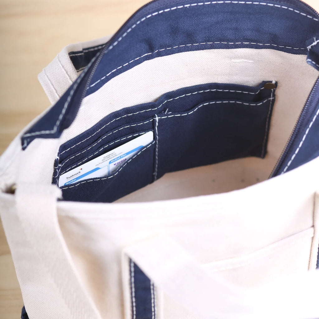 Interior view of ShoreBags Sonoma Canvas Crossbody Tote bag with a small pocket containing a card.
